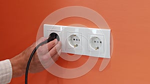 Removing Black Plug from White Electrical Outlet