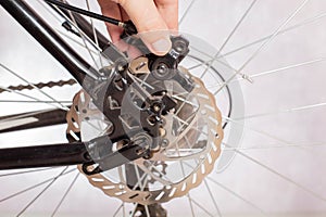 Removing the brake caliper on a bike with disc brakes. Replacement and adjustment of brake pads. Bicycle service. Copy