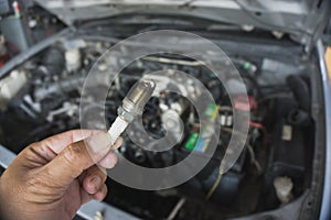 Removing car spark plugs at garage