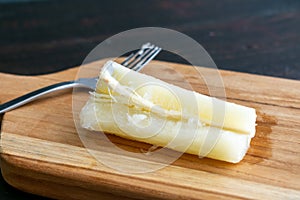 Stemming a piece of boiled yuca with a fork photo