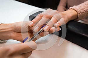 Removing the cuticle by manicure nippers