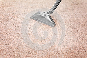 Removing dirt from carpet with professional cleaner indoors