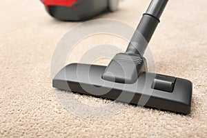 Removing dirt from carpet with vacuum cleaner, closeup