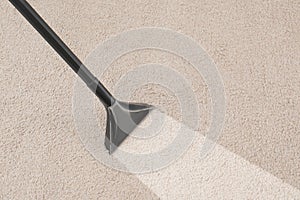 Removing dirt from carpet with vacuum cleaner