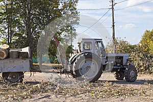 Removing fallen tree with tractor and loader