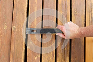 Removing old wooden boards with Pry Bar
