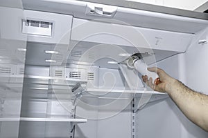 Removing a refrigerator air filter photo