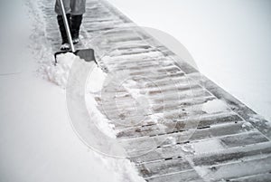 removing the snow from a hard floor of the patio