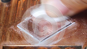 Removing thermal paste with cotton from heatsink. Close up macro