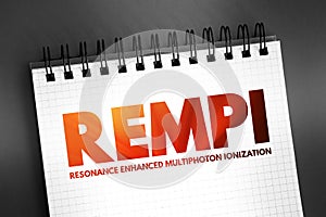 REMPI - resonance-enhanced multiphoton ionization acronym text on notepad, abbreviation concept background