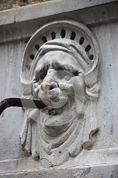 Renaissance fountain with a mask
