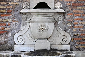 Renaissance fountain with a mask in Rome