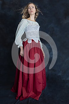 A Renaissance or Gypsy woman wearing a brocade corset and red skirt