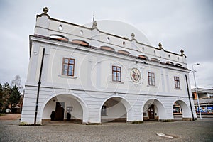 Renaissance town hall with arcades at main Masaryk Square, historical building in city centre, spa resort in winter day, Lazne