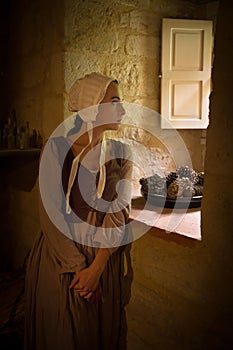 Renaissance woman standing at window