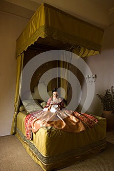 Renaissance woman under canopy of her bed