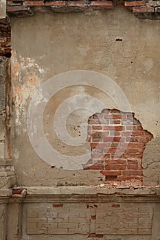 Rendered concrete wall with exposed red brick abstract