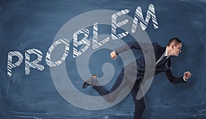 Rendering of businessman running to escape the word 'problem' written on dark blue wall.