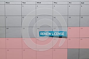 Renew License write on Sticky Note above calendar. Reminder or Schedule Concepts