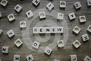 Renew word made of square letter word on wooden background