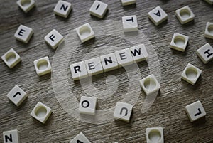 Renew word made of square letter word on wooden background