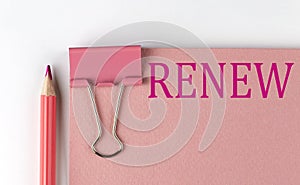 RENEW word on the pink paper with pink pencil