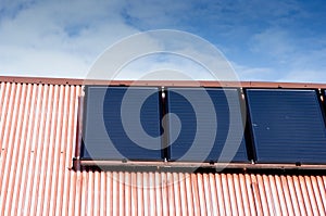 Renewable clean green energy saving efficient photovoltaic solar panels on multiple gable suburban house roof over blue sky Manche