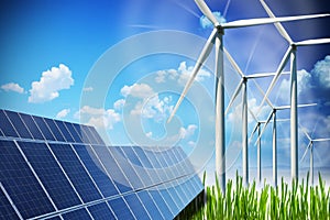 Renewable energy concept with solar panels and wind turbines on green field