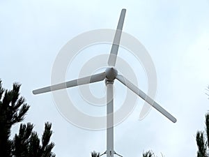 Renewable Energy Concept Wind turbine over blue sky background