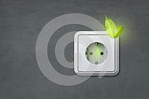 Renewable energy outlet with glowing green leaves