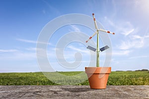 Renewable energy production concept - Wind turbine as a plant in a flower pot