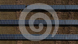 Renewable energy source from above. Birds eye view of rows of photovoltaic panels. Green energy, ecology and carbon