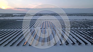 Renewable green energy and electrical technology. Field of Solar Panels Stands in a Row in the Fields for Power