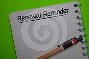 Renewal Reminder write on a book isolated on Office Desk photo