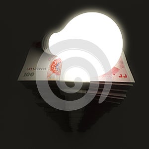 Renminbi stack with shiny lightbulb