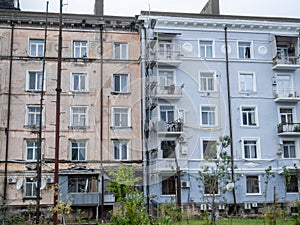 Renovated and old part of the house. Facade repair. Renovation in the old town. Khrushchevka. Old and new