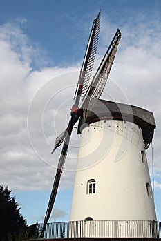 Renovated old white windmill