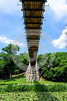 Renovated suspended metallic bridge in Nicolae Romaescu park from Craiova in Dolj county, Romania, in a beautiful sunny spring day