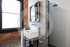 Renovated warehouse bathroom with vintage basin