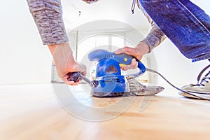 Renovating at home: sander tool for refreshing and grinding the wooden parquet floor