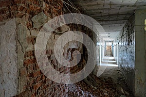 Renovation in the apartment. Destroyed buildings after an earthquake or cataclysm. Walls without plaster and broken red brick.