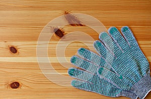 Renovation concept: a pair of work gloves on a wooden table