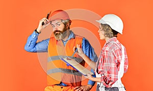Renovation concept. Price list. Couple look documents. Woman and man safety hard hat. Couple planning changes renovation