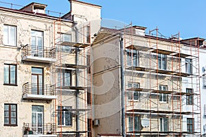 Renovation of old building facade. metal scaffolding near wall