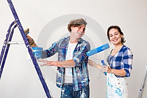 Renovation, redecoration and people concept - Portrait of couple stained with paint over white background