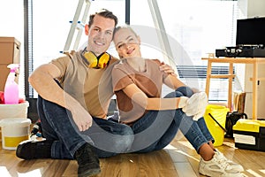 Renovation, repair and family concept. Happy couple doing repair in new home, relaxing