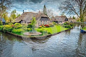 Dutch village with colorful ornamental garden and spring flowers, Giethoorn