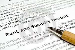 Rent and security deposit with wooden pen photo