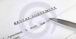 Rental agreement form on desktop with pen in business office showing real estate concept