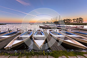 Rental boats in a marina at sunrise